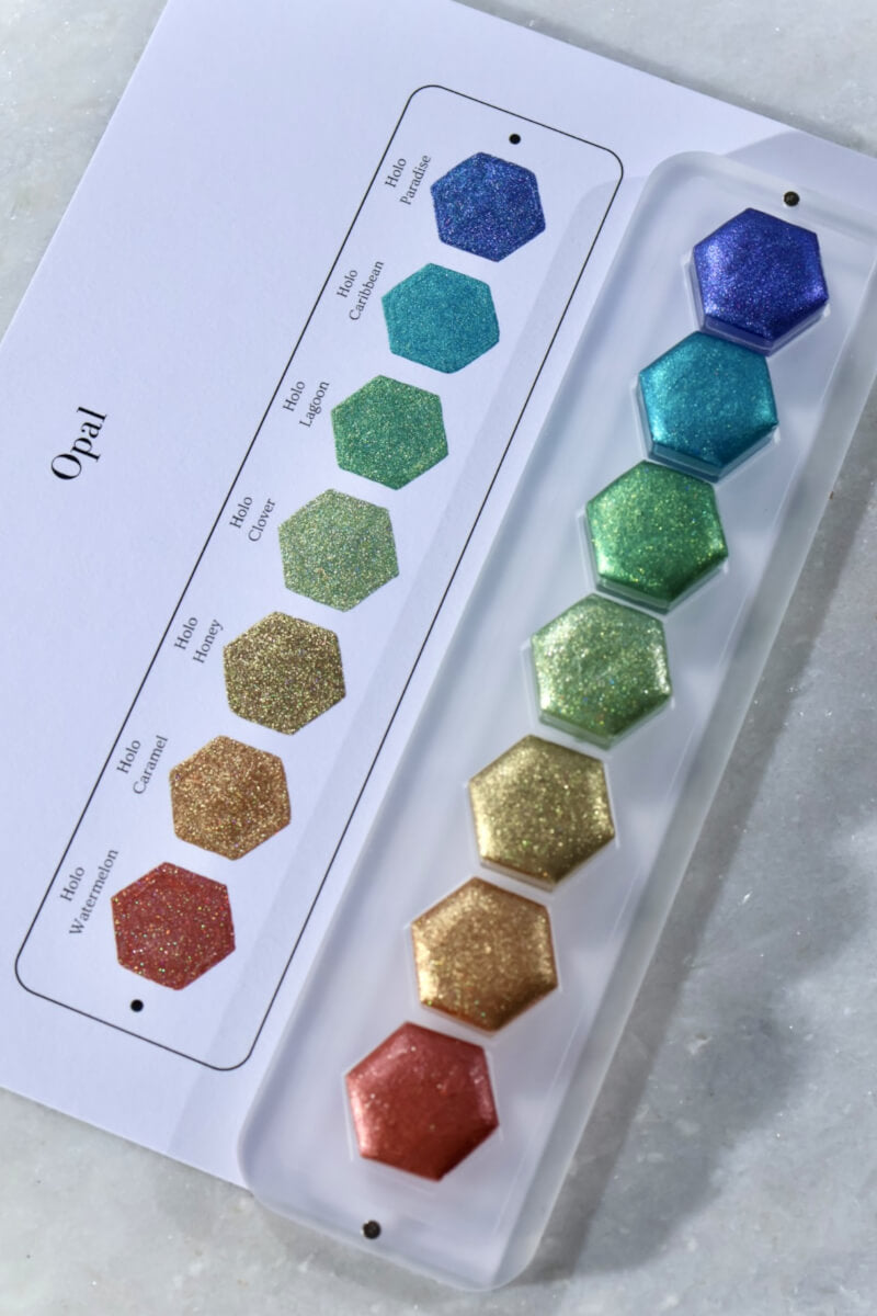 Lisilinka Opal Set with swatch card — seven holographic watercolors in hexagon pans, handmade in Hannover