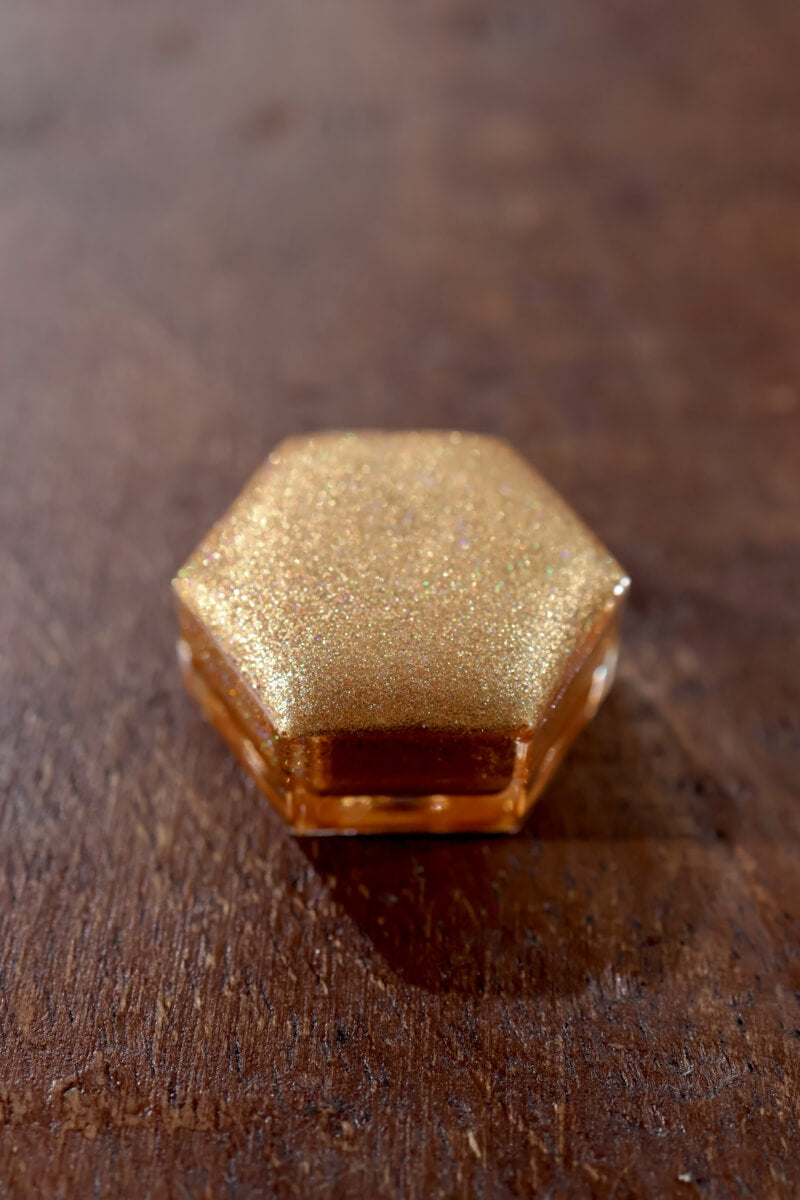 Holographic watercolor close-up showing prismatic light-reactive shimmer in a Lisilinka Opal pan