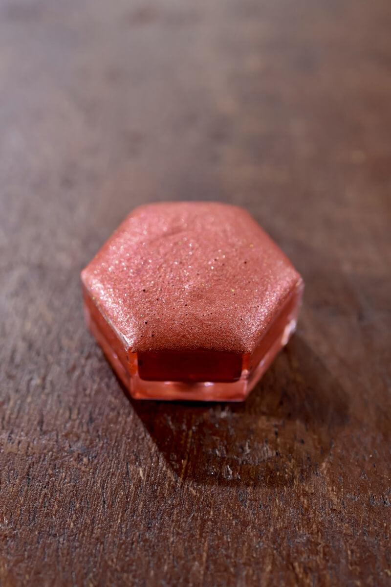 Holographic watercolor close-up showing prismatic light-reactive shimmer in a Lisilinka Opal pan