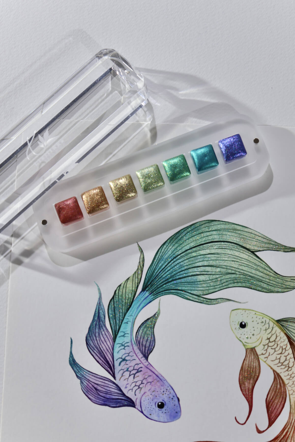 Iridescent fish painted with Lisilinka Opal holographic watercolors, showing color-shifting pigments